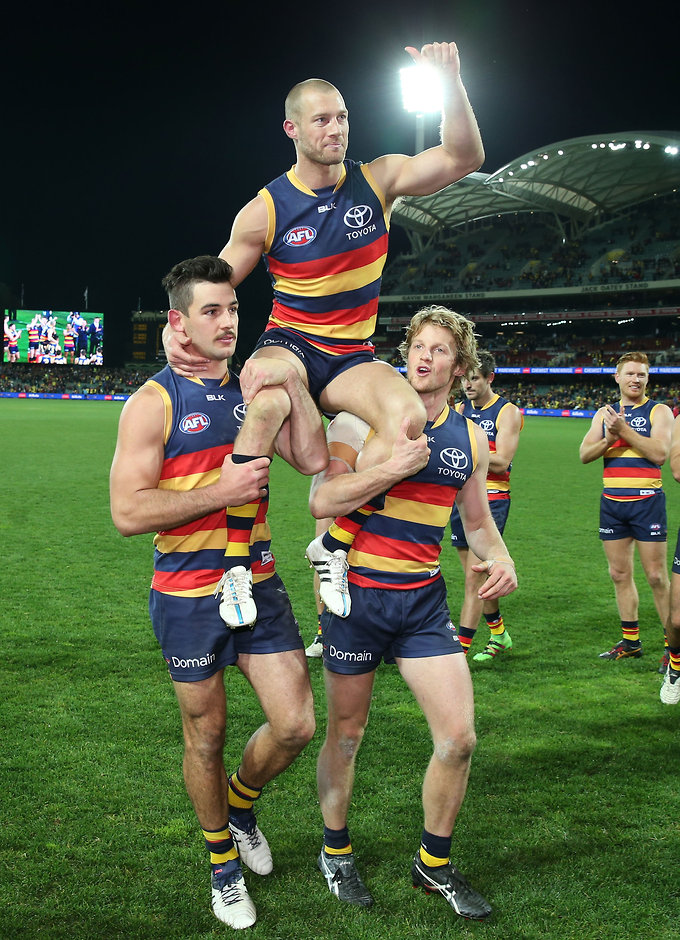 AFL 2016 Rd 17 - Adelaide v Collingwood ADELAIDE, AUSTRALIA - JULY 16: Scott Thompson of the Crows celebrate his 300th game with Taylor Walker and Rory Sloane during the 2016 AFL Round 17 match between the Adelaide Crows and the Collingwood Magpies at the Adelaide Oval on July 16, 2016 in Adelaide, Australia. (Photo by James Elsby/AFL Media)